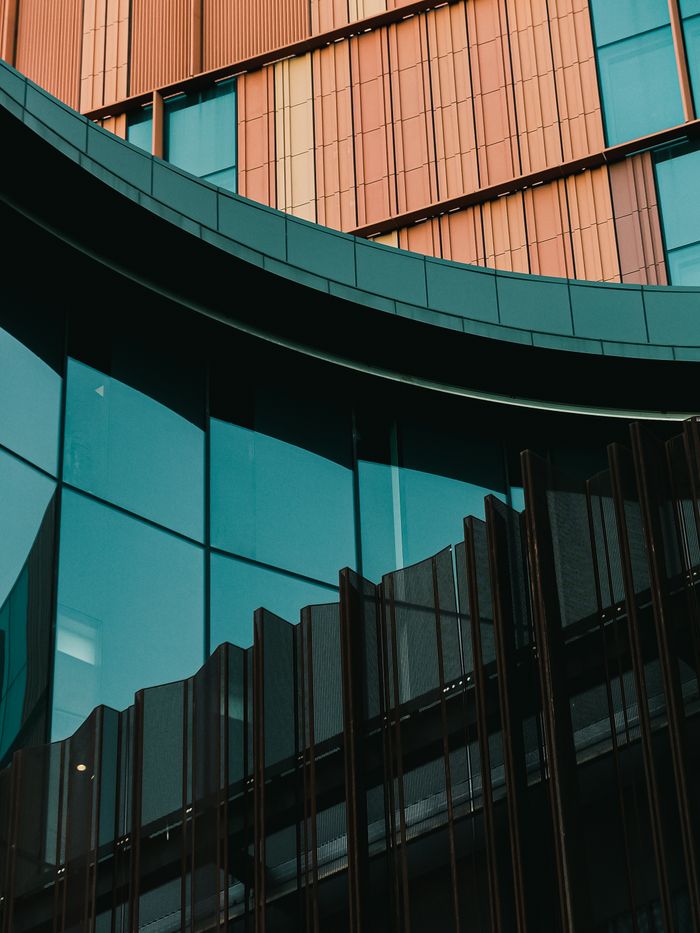 Crafting Captivating Headlines: Your awesome post title goes here Closeup of a modern building facade with glass and metal elements showcasing urban architecture.
